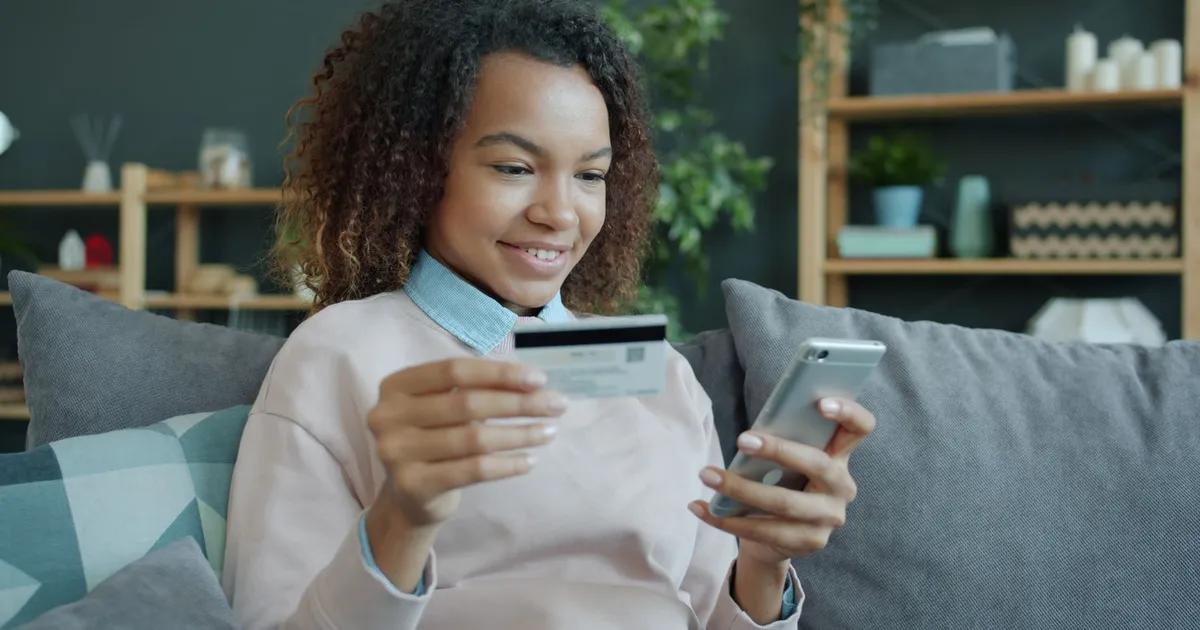 Happy person checking a $1500 loan guaranteed approval deposit in their online banking app