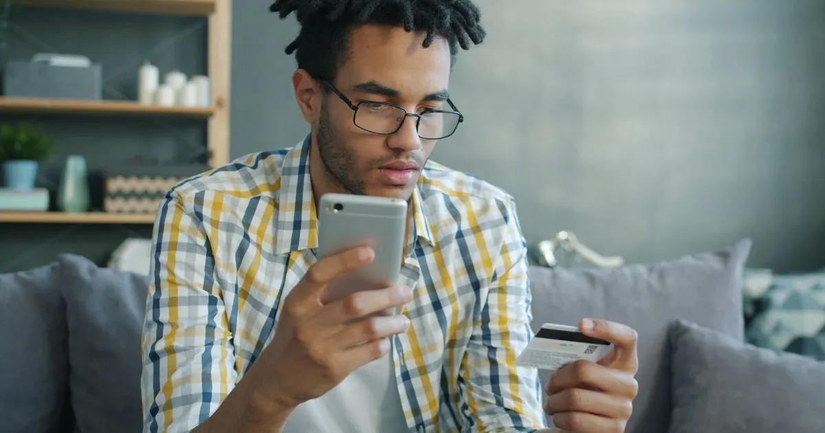 Person checking a 500 credit score loan offer on a phone