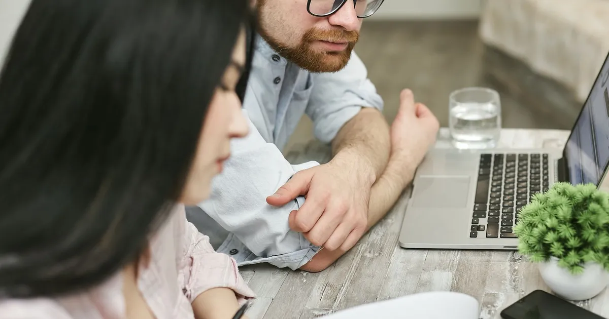 Man reviewing a bad credit installment loans agreement on his laptop at home