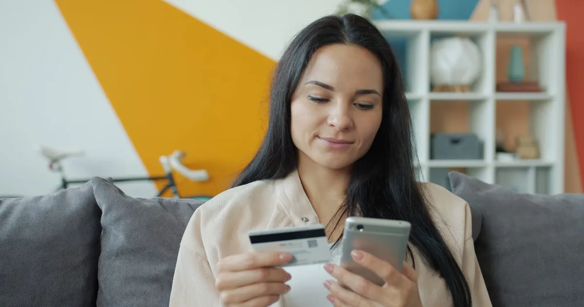 Man smiling at a bad credit loans guaranteed approval decision on his laptop
