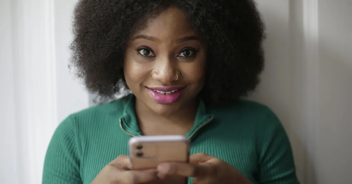 Woman reading an approved message for bad credit loans no refusal on her phone