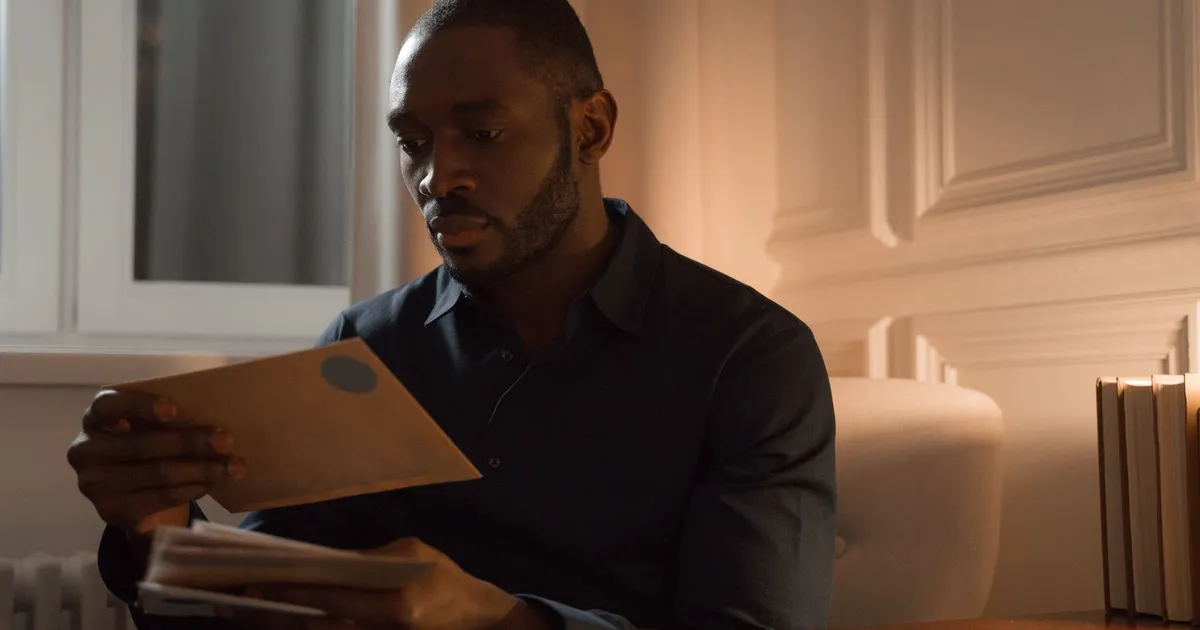 Disappointed man reading a loan denied letter at home
